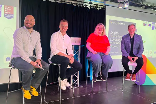 Panel discussion taking place on stage at TechNExt, from L-R Steve Morland, Leighton CTO and moderator, James Eastham Senior Cloud Architect at AWS, Julia Dann Solutions Architect at Immediate Media Co and Mark Joyce CTO at Preventx.