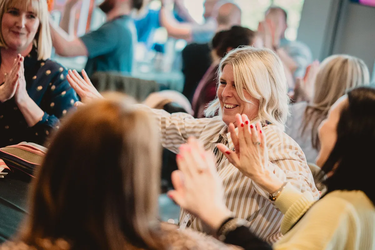 Leighton colleagues smiling together in a group setting.