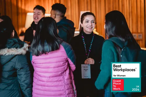 Leighton colleagues talking together in a group setting.