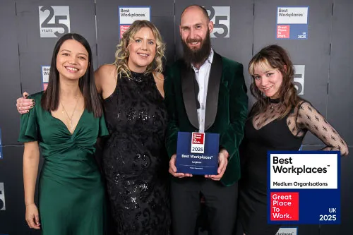 Leighton colleagues stand together holding the UK's Best Workplace award. 
