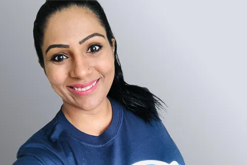 Head and shoulders photo of Suman Bala looking directly at the camera smiling