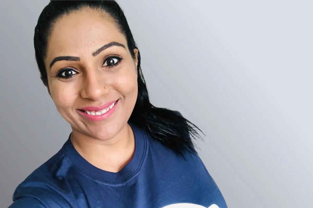 Head and shoulders photo of Suman Bala looking directly at the camera smiling