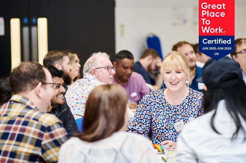 Leighton colleagues laughing together, overlaid with the Great Place to Work logo 