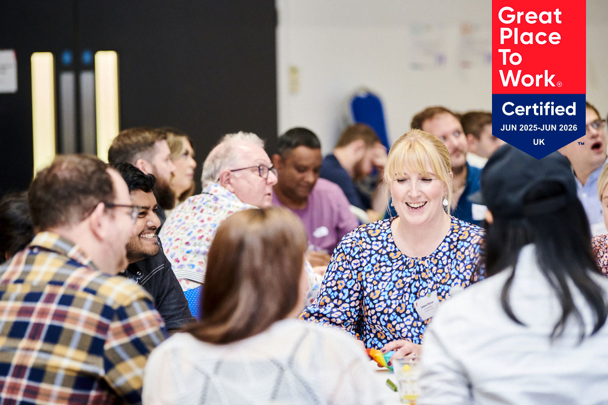 Leighton colleagues laughing together, overlaid with the Great Place to Work logo 