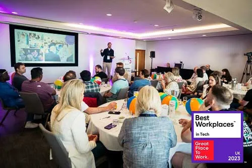 Leighton colleagues sat watching a presentation at a Leighton company day. 