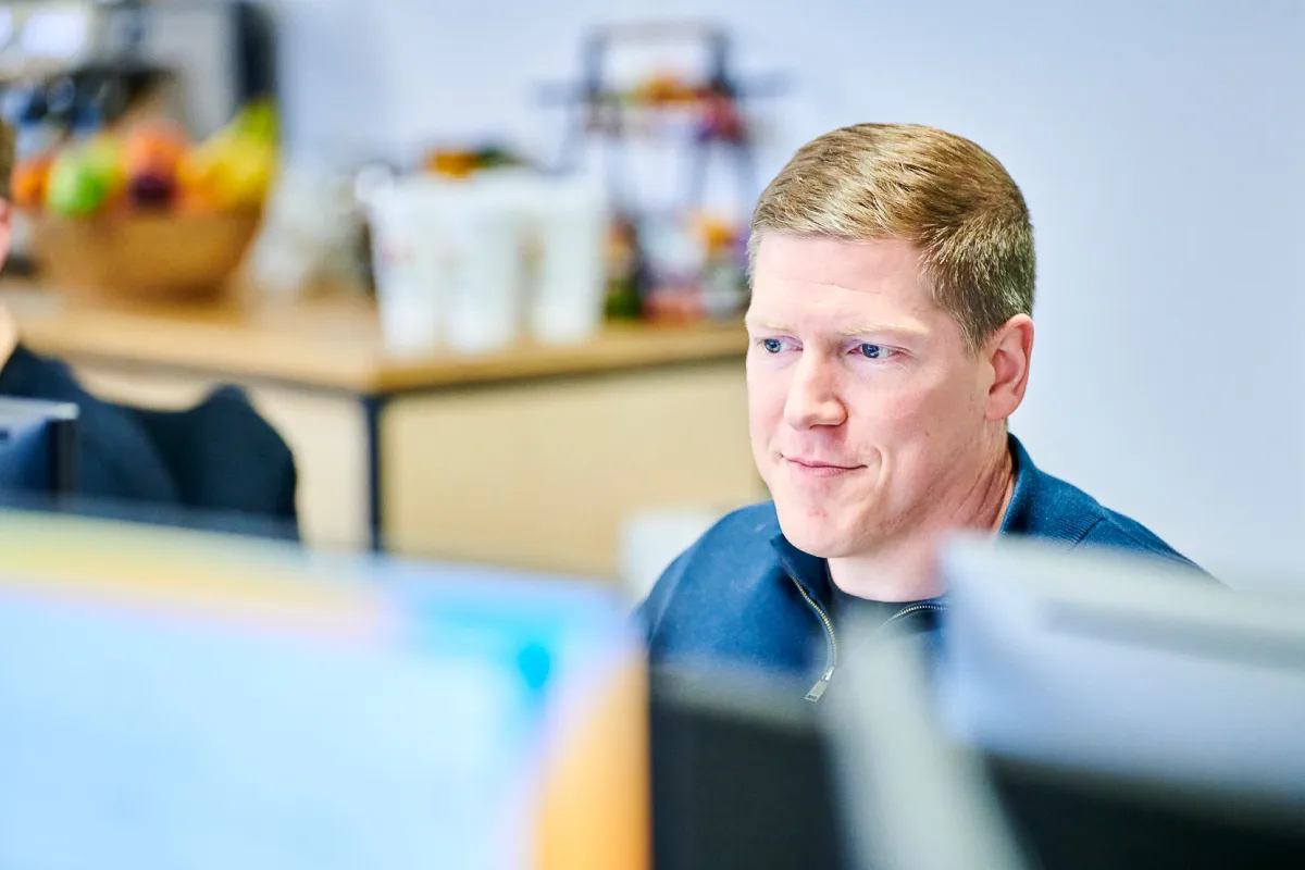 Leighton Chief Financial Officer, Andy Carr sat working at a computer.