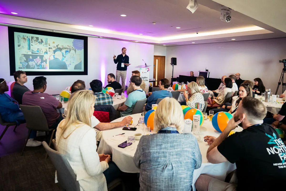 Leighton colleagues sat watching a presentation at a Leighton company day. 