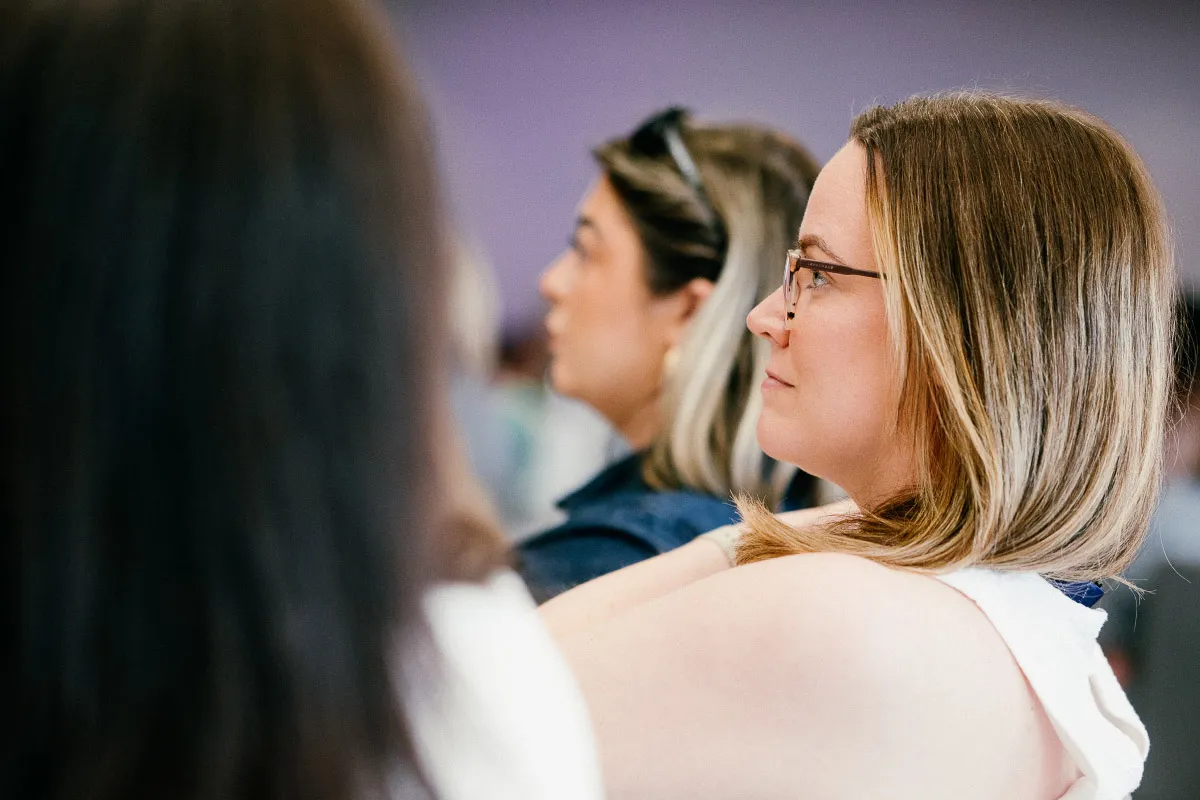 A Leighton colleague sat in a group setting watching a presentation.