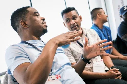 Two Leighton colleagues sat together in discussion. 