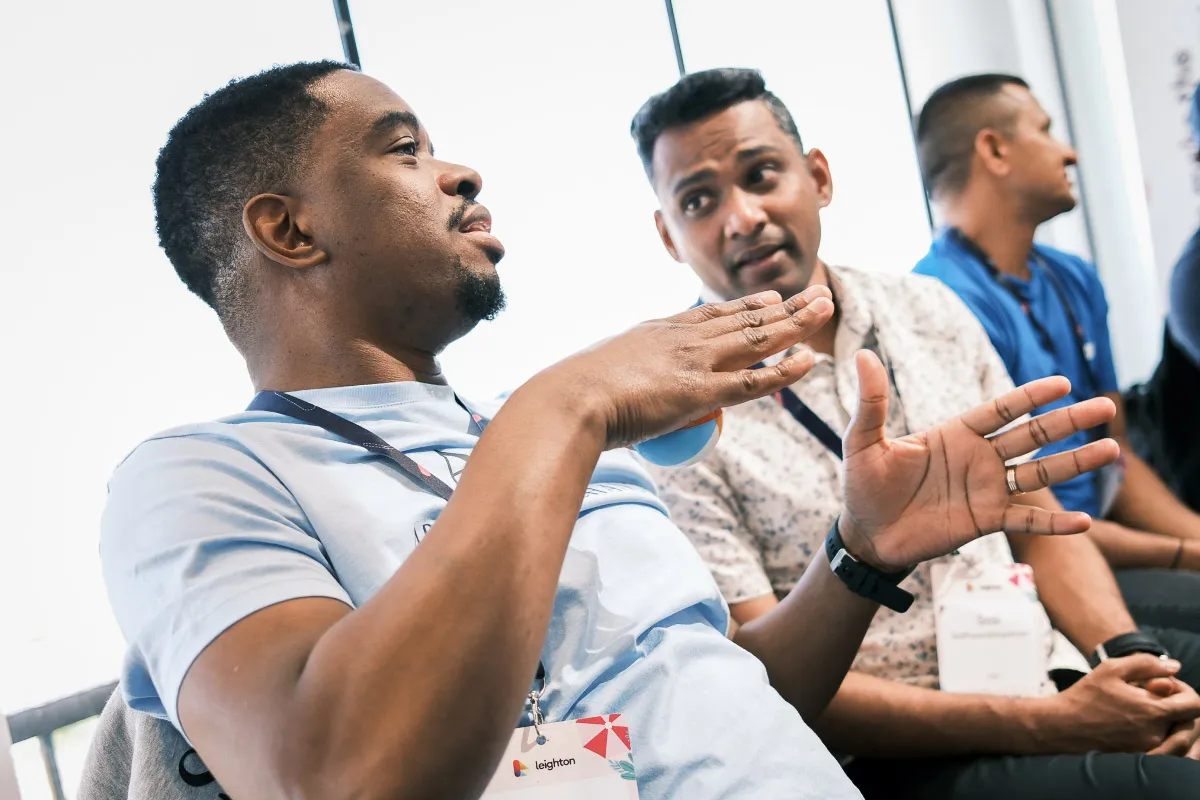 Two Leighton colleagues sat together in discussion. 