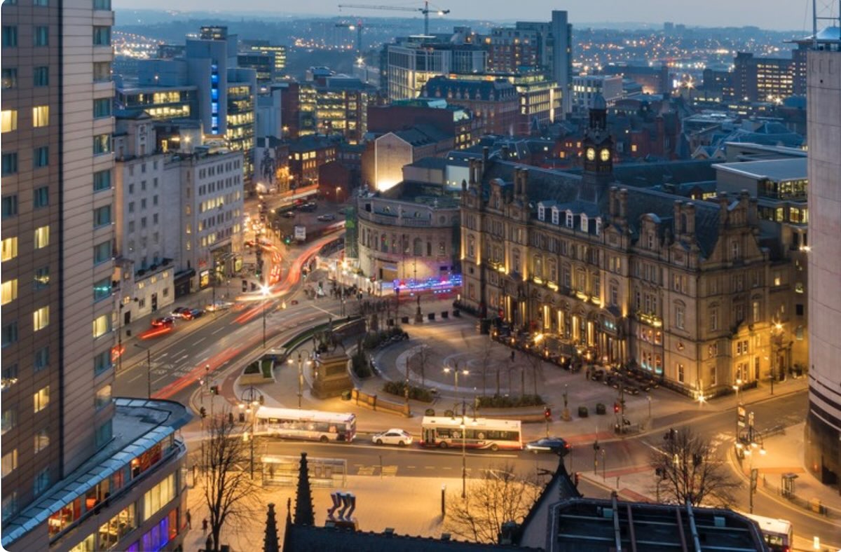 A photograph of Leeds city centre in the evening. 