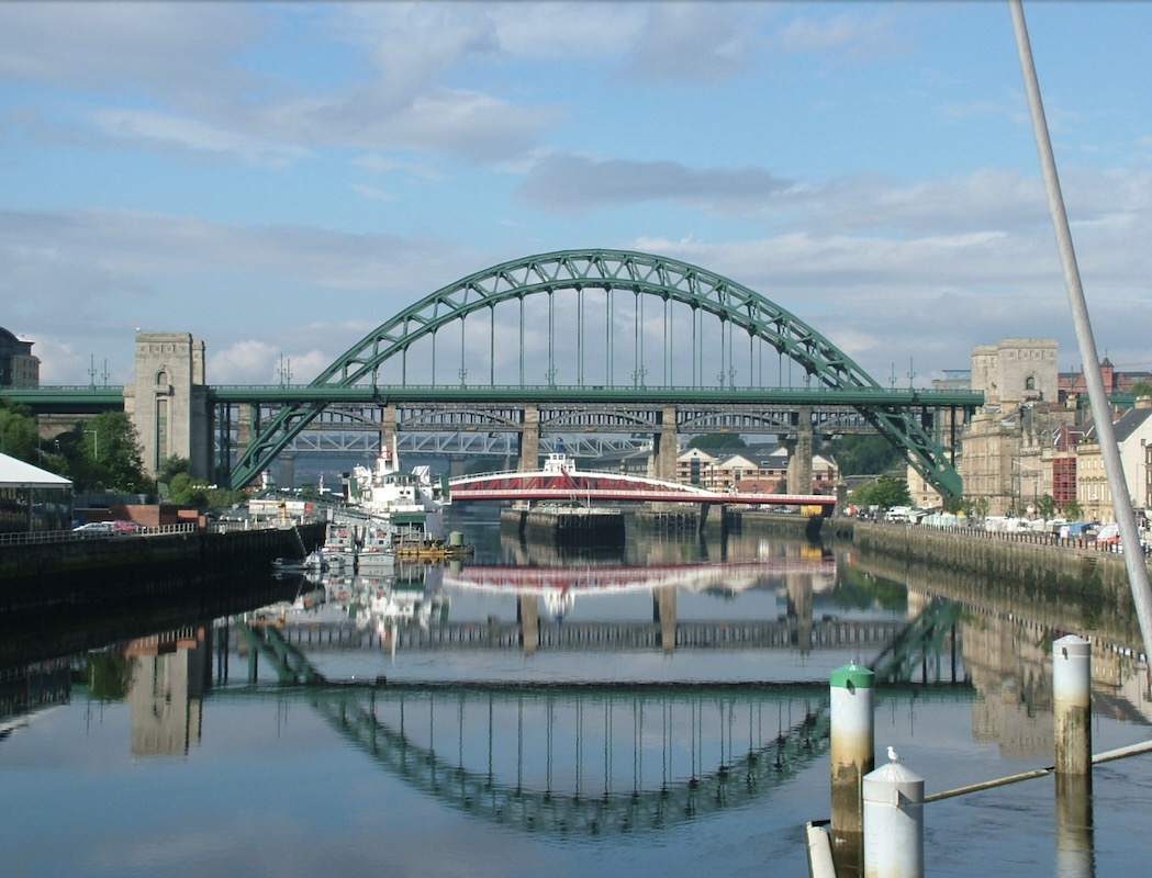 A photograph of the Tyne bridge, reflecting on to the River Tyne.