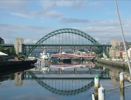A photograph of the Tyne bridge, reflecting on to the River Tyne.