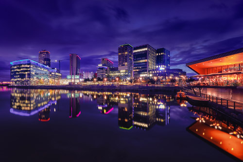 A photograph of the Manchester skyline at night. 