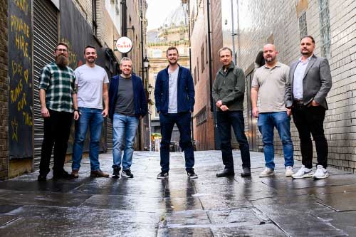 Members of Leighton's AWS Practice stood together, looking at the camera. 