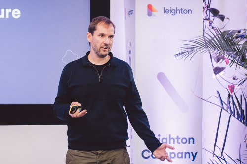 Leighton CEO James Bunting on stage delivering a talk. 