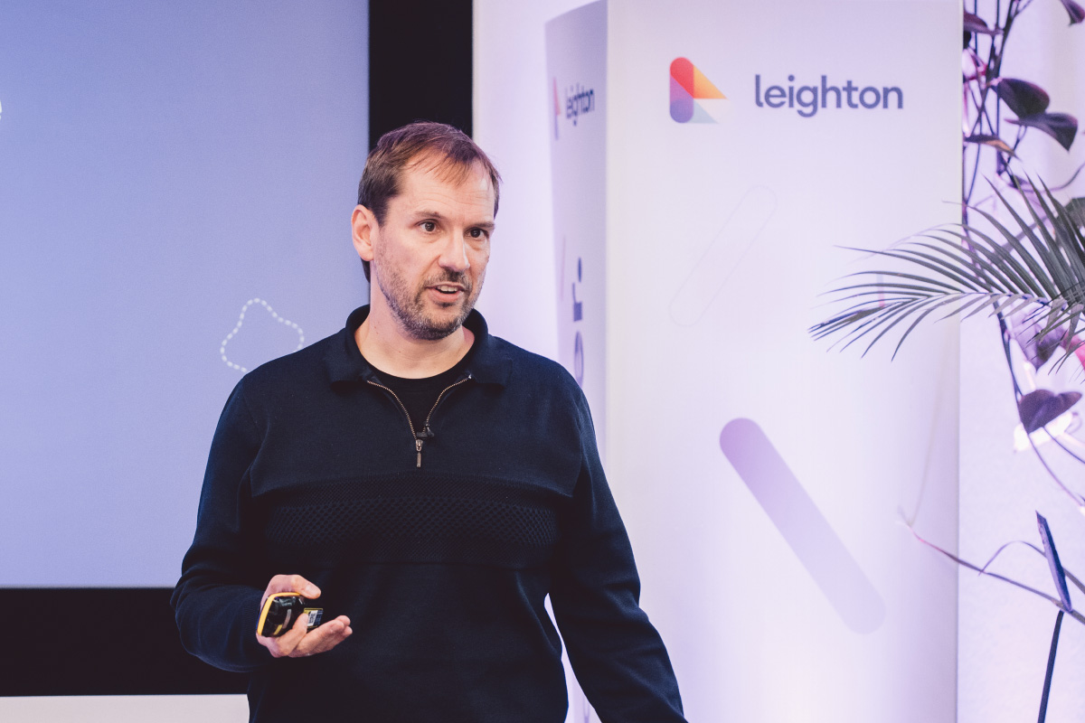 Leighton CEO James Bunting on stage delivering a talk. 