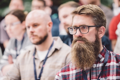 A Leighton colleague listening to a presentation. 