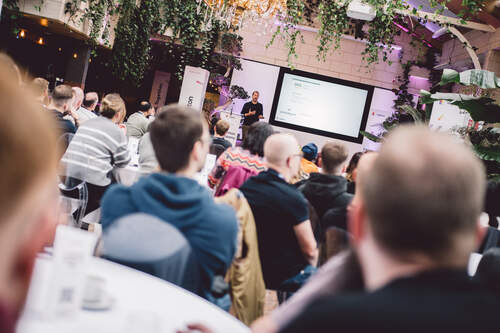 A member of the Leighton leadership team giving a talk on stage. 