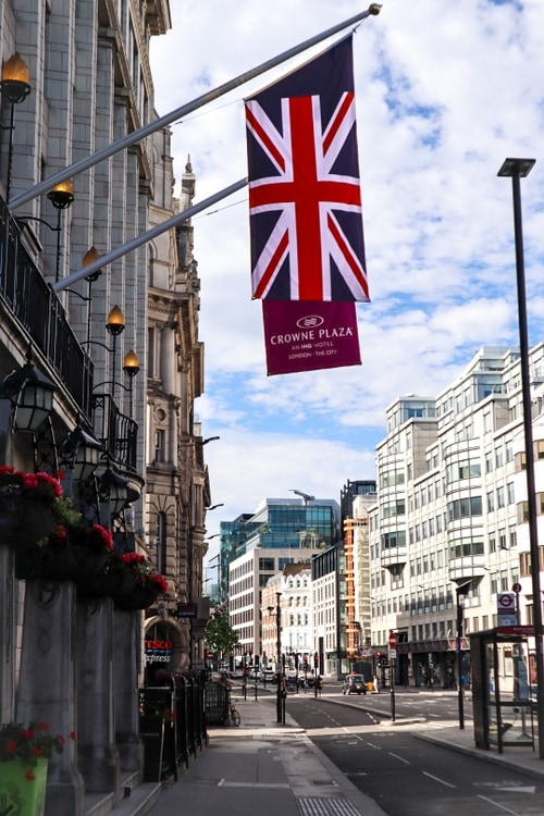 UK flag hangs off of an old building on a central London road