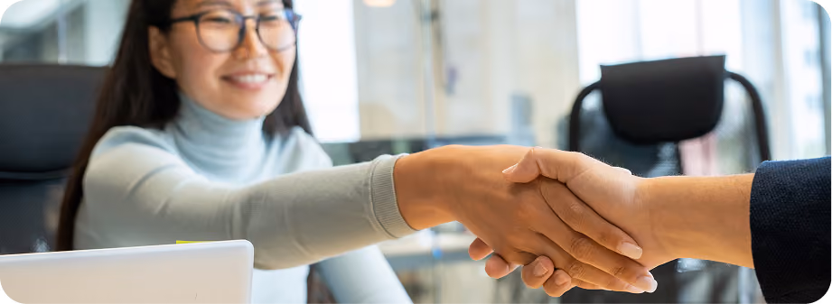 two women shaking hands