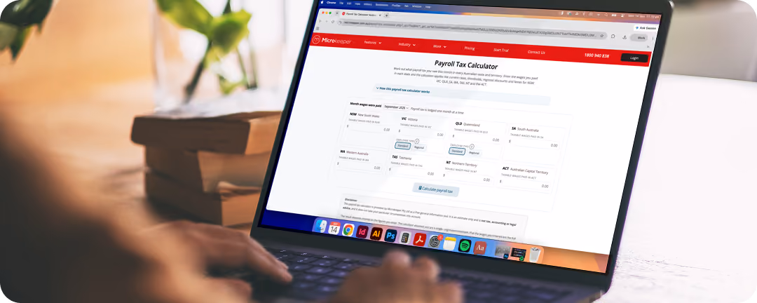 Person using a laptop displaying the Microkeeper Payroll Tax Calculator webpage, showing fields for wage type, employment, and tax year selection.