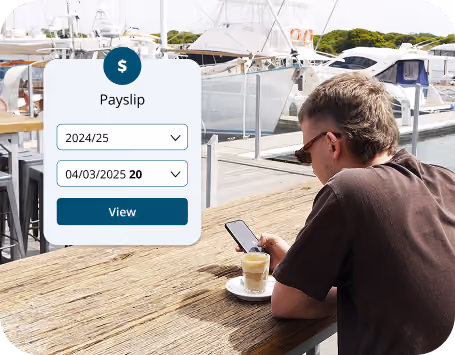 Man wearing sunglasses sitting at a wooden dockside table near yachts, looking at his phone with a latte in front of him. Overlay of a payslip interface shows dropdown menus for 2024/25 and 04/03/2025 with a View button.