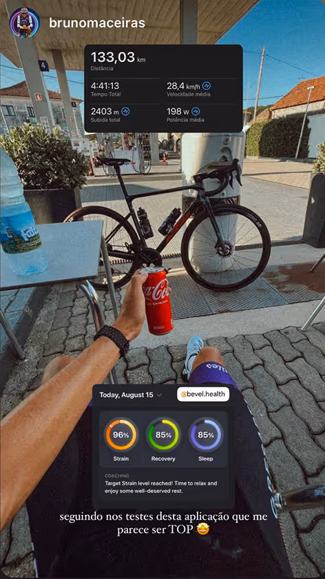 Cyclist holding a can of Coca-Cola, resting next to a black road bike at a gas station, with fitness app stats showing 133 km distance, 4:41:13 duration, and 96% strain.