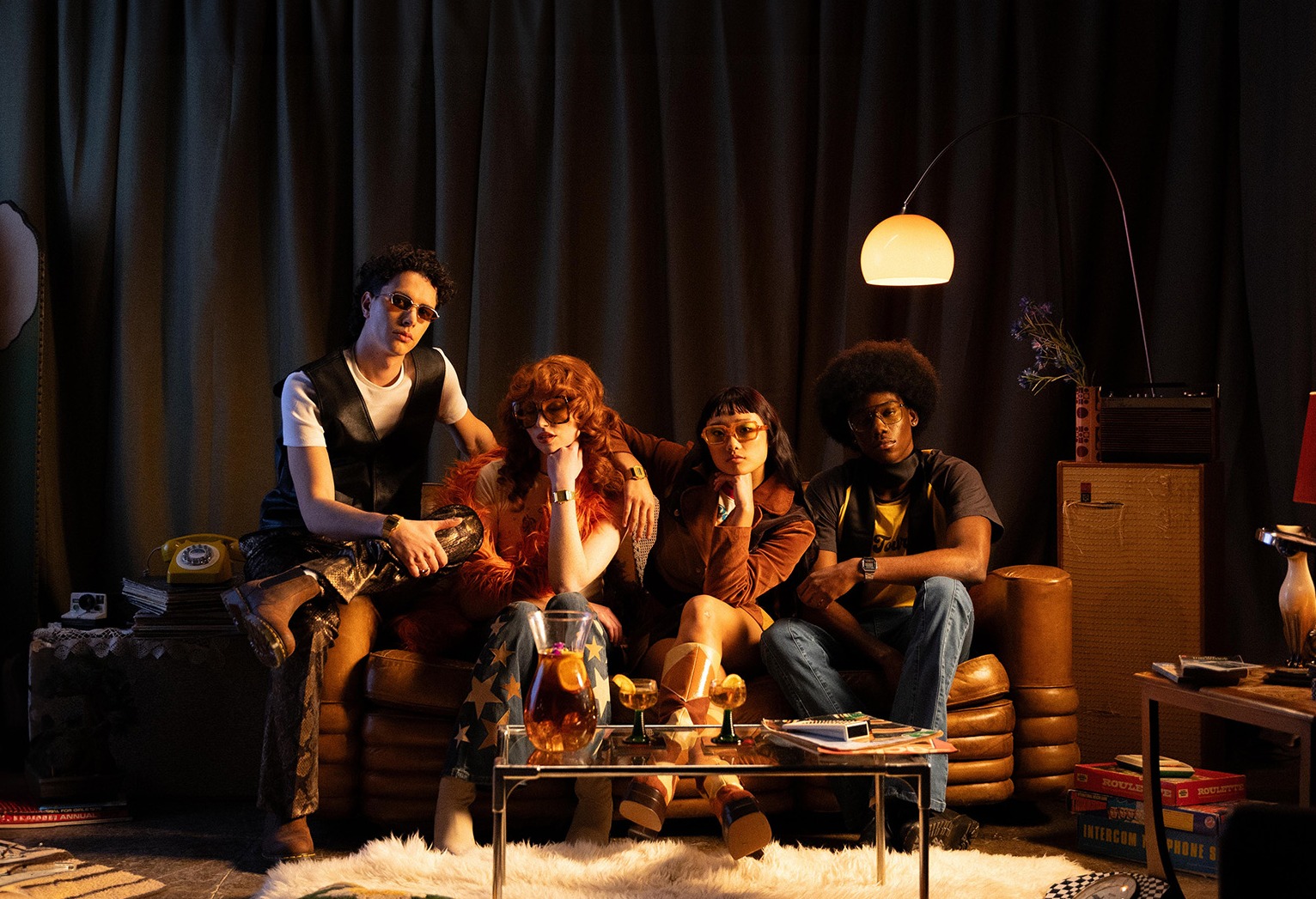 Casio Vintage campaign, four friends in 70s styling on a leather sofa