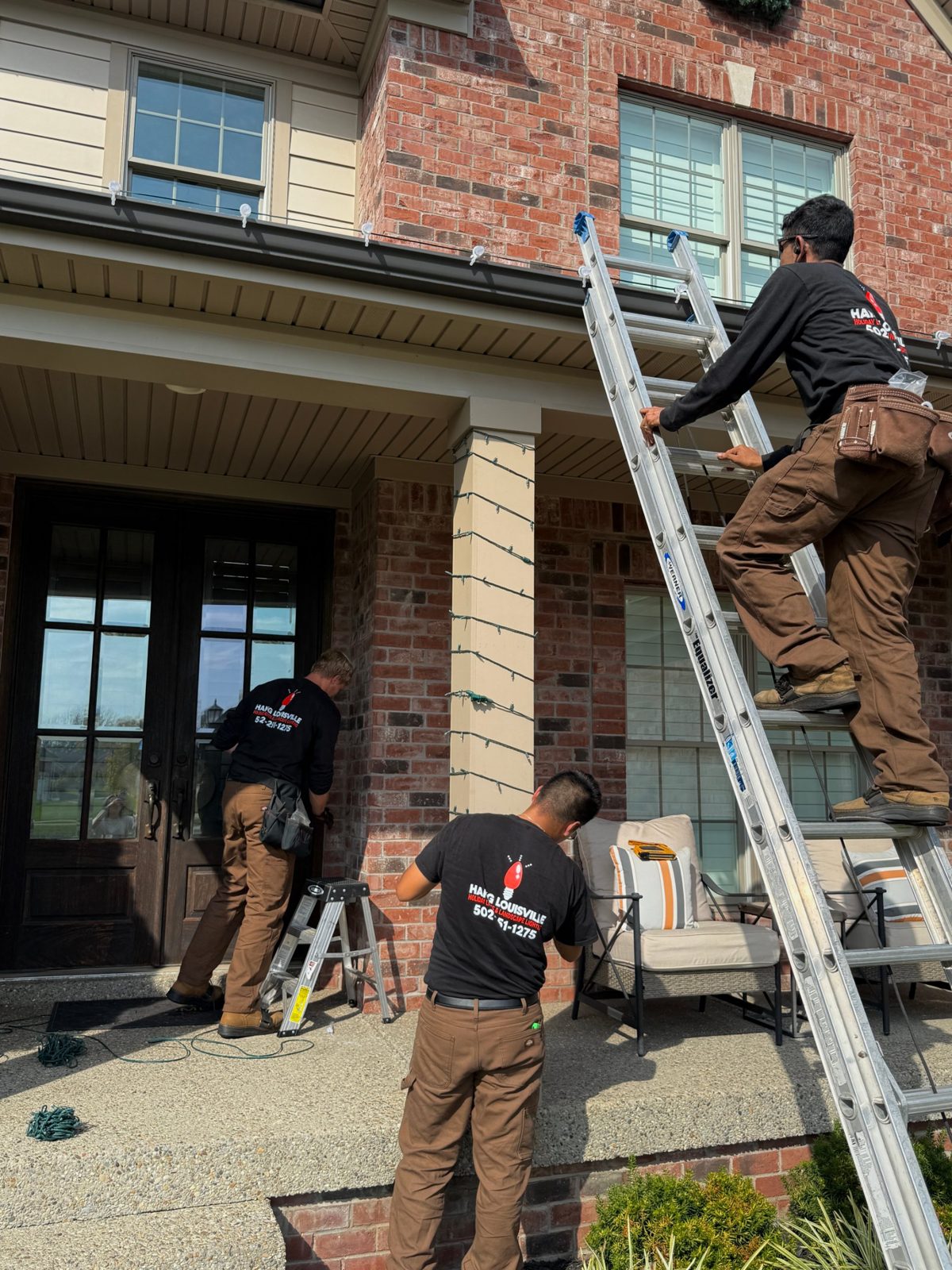 Hang Louisville crew installing lights on a porch