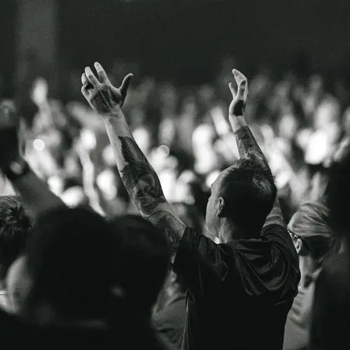 Worshipper raising hands in praise at Southeast Christian Church.