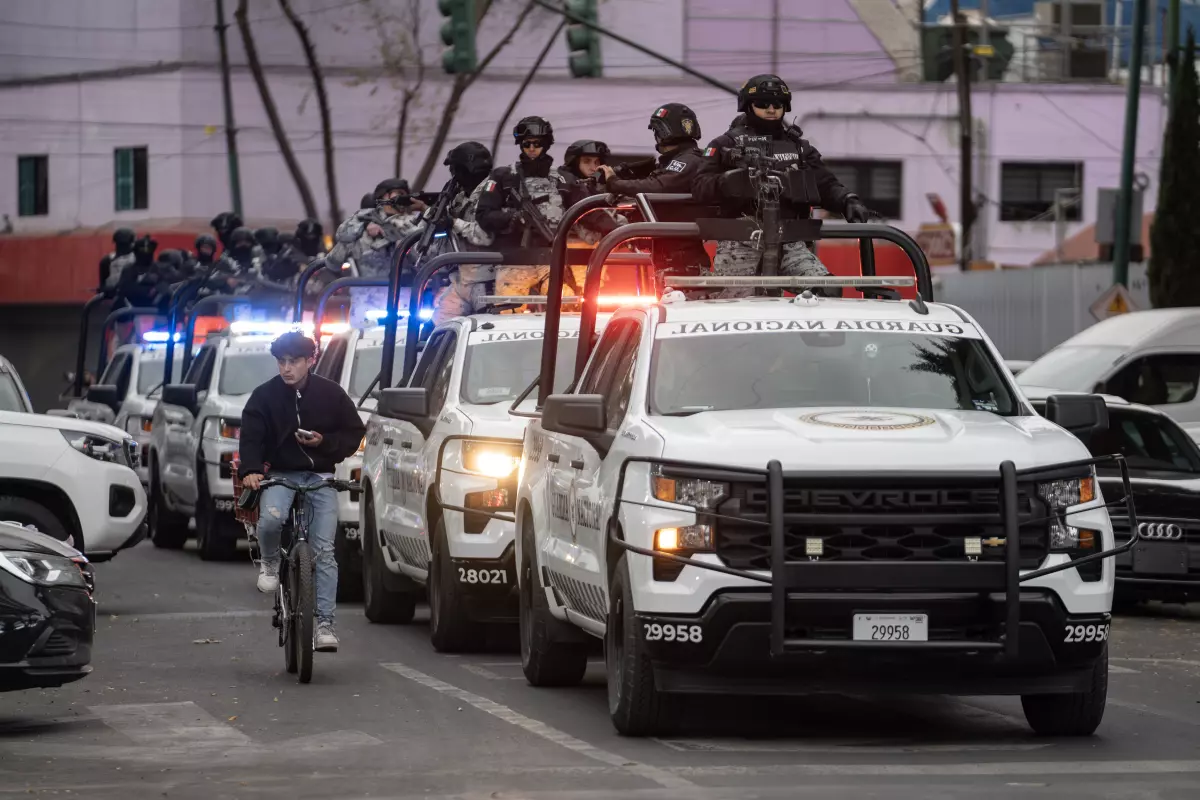 Soldiers guard the federal attorney general’s office in Mexico City, which is investigating the operation that killed cartel leader Nemesio Rubén Oseguera Cervantes. (Felix Marquez / Getty Images)