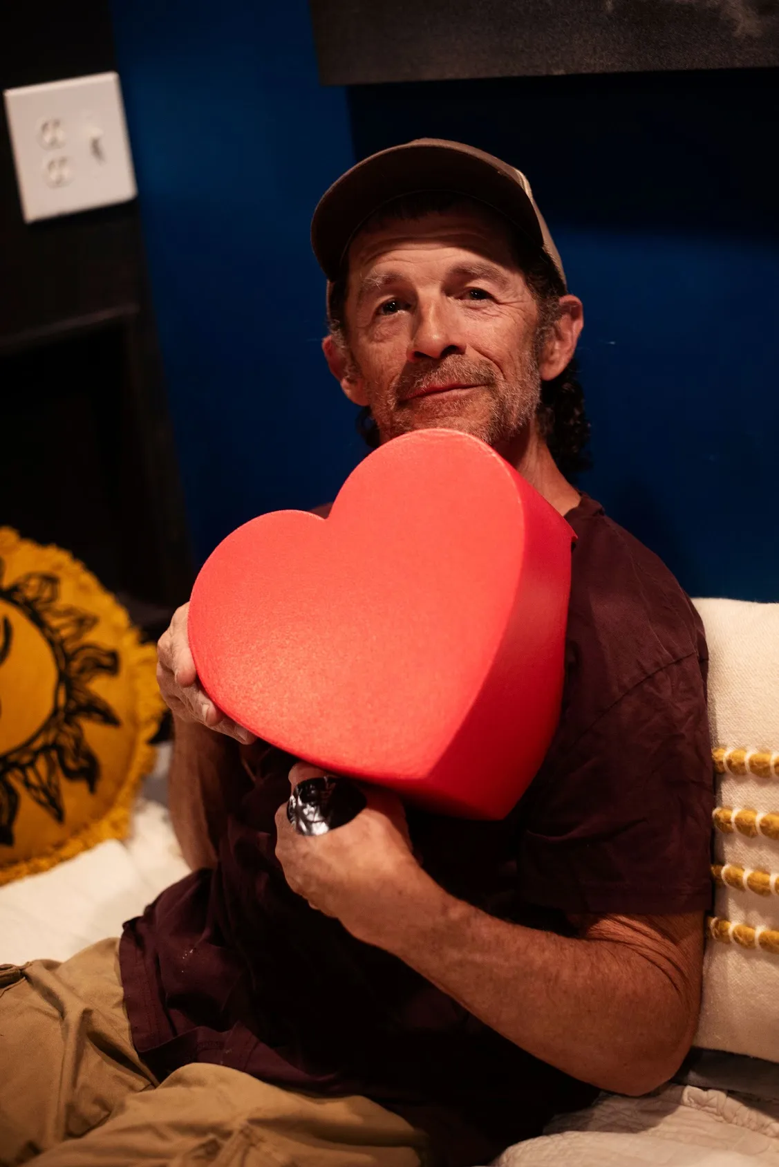 Man holding a heart sponge