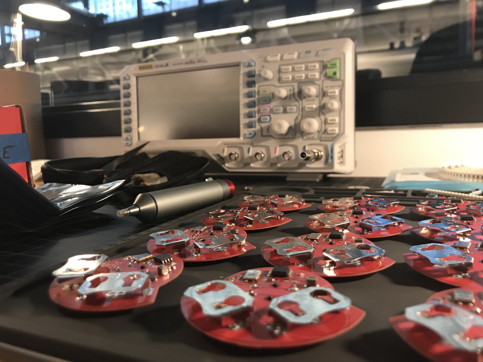 Custom red PCB boards on electronics workbench