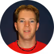 man_in_red_shirt_with_a_black_necklace_headshot_google_review_testimonial