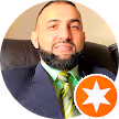 man_with_beard_and_green_tie_black_suit_smiling_orange_star_in_bottom_right_corner_for_deeded_google_reviews