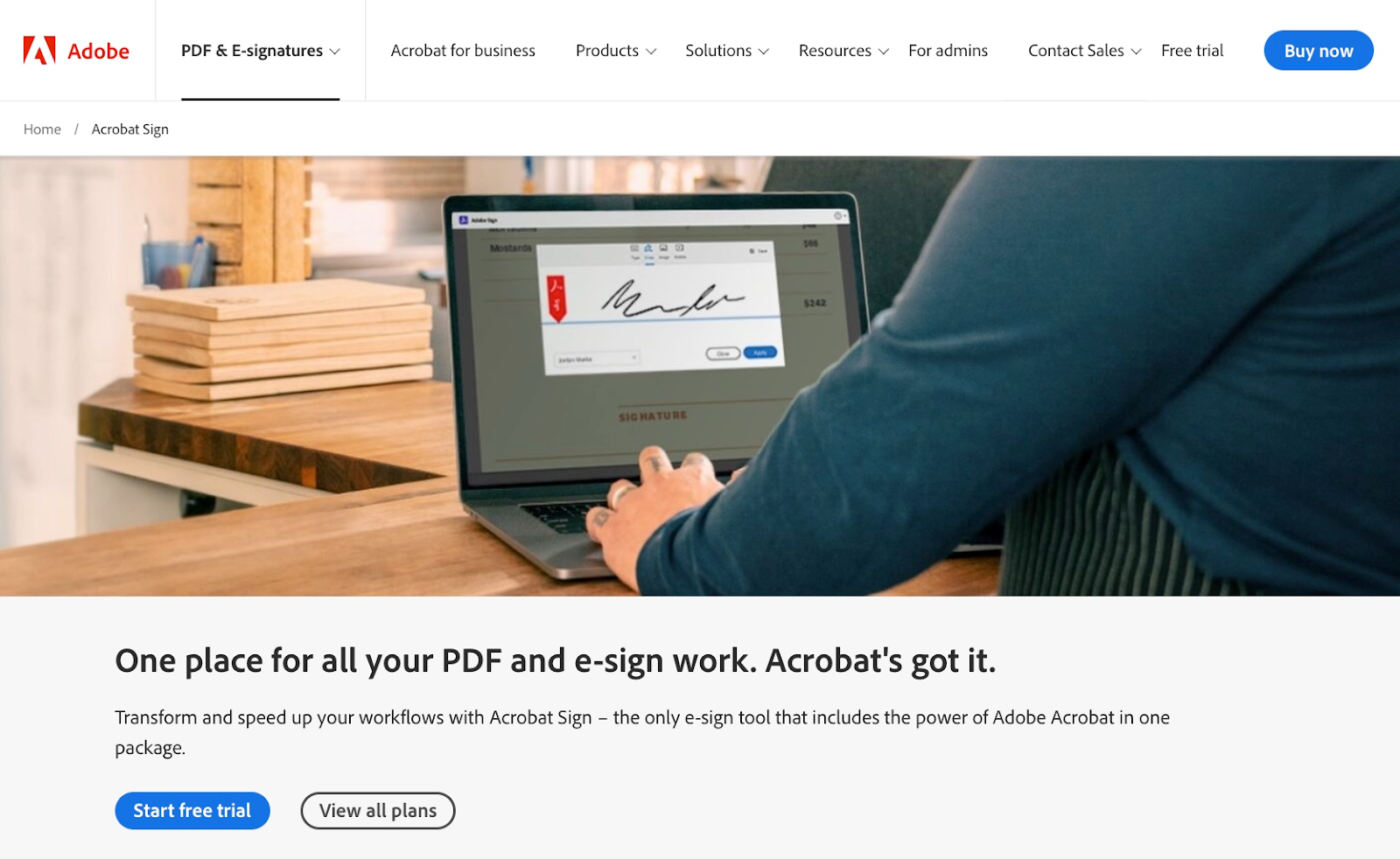 Person is digitally signing a document on their laptop using Adobe Sign.