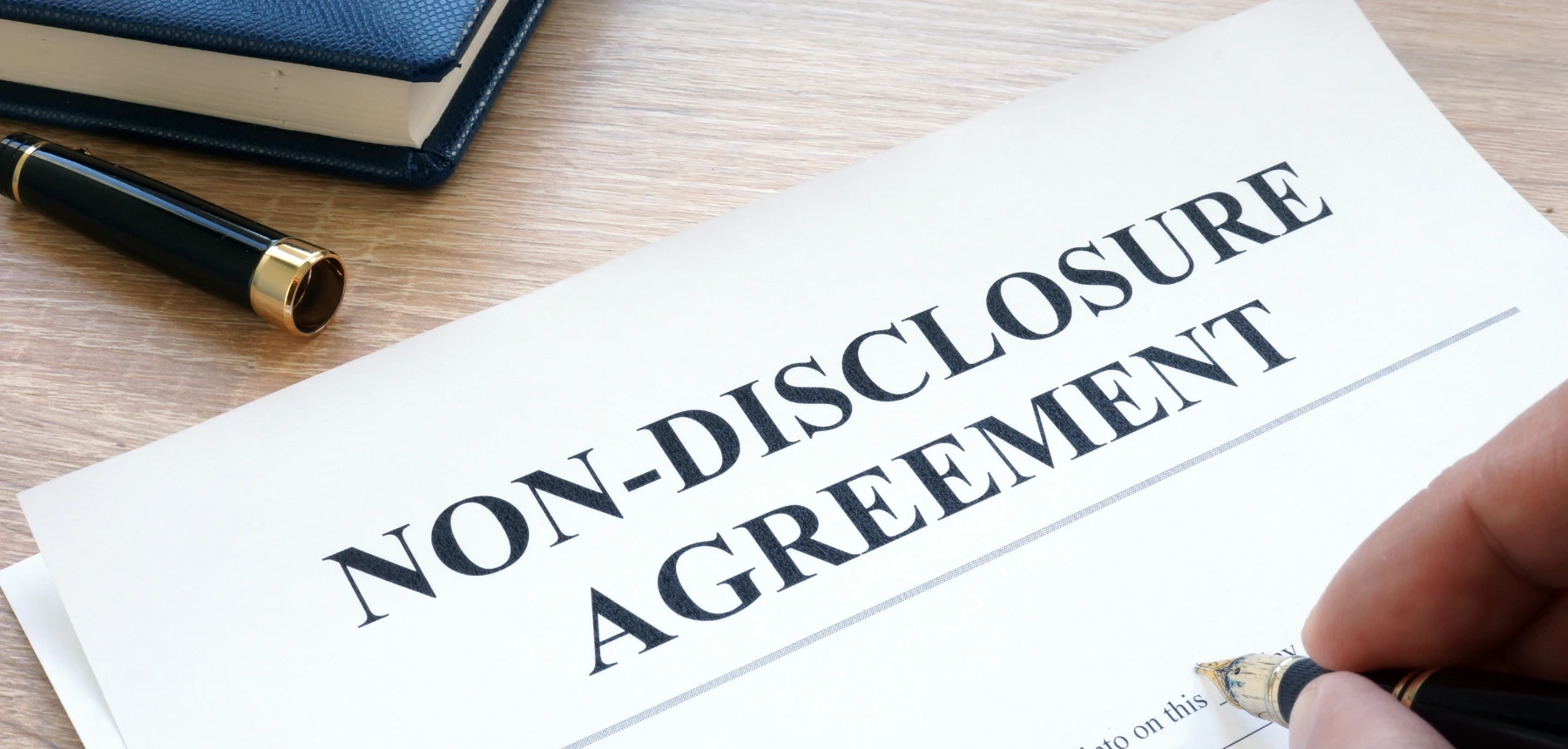 Non-disclosure agreement on desk with pen