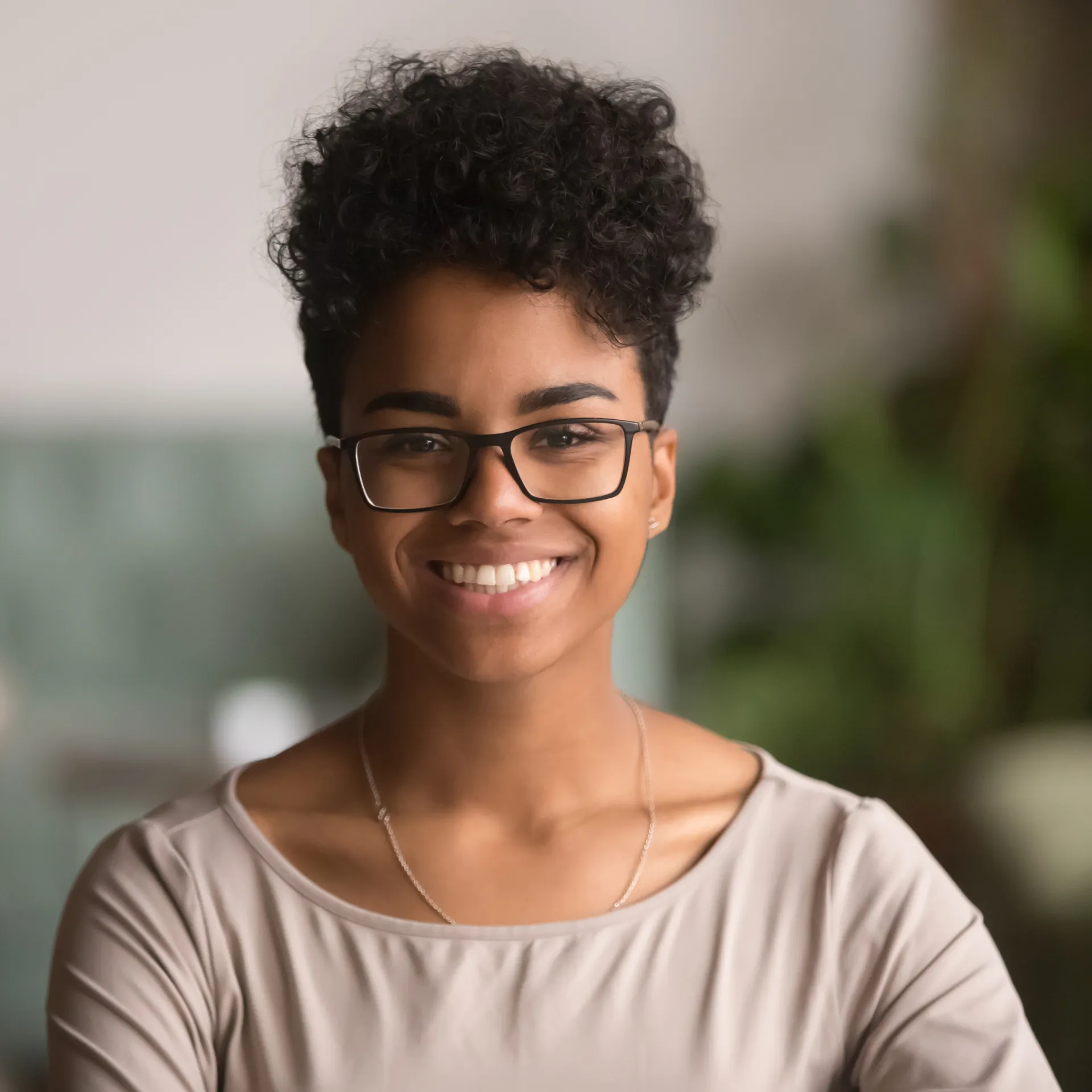 a woman with glasses smiling for the camera