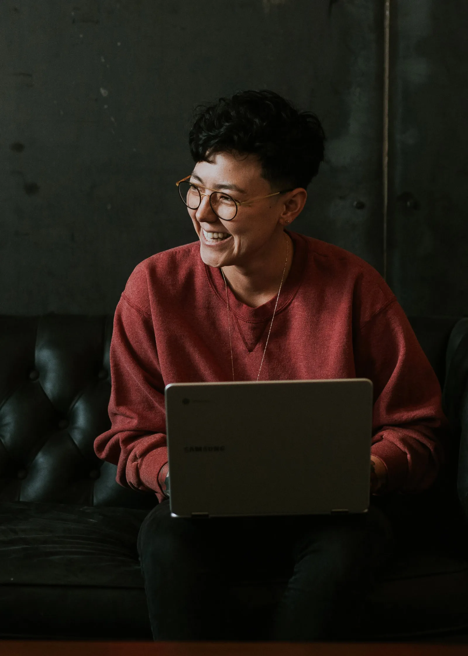 Young woman smiling while on laptop