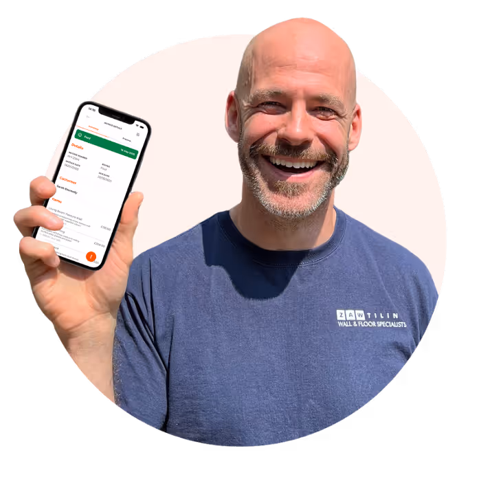 Zac, owner at Zaw Tiling smiling while standing holding up his iPhone with the NabyPay app open.