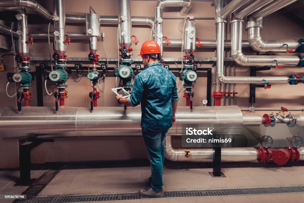 Mechanic responsibly refilling fluids, mindful of GMG's hazardous material protocols