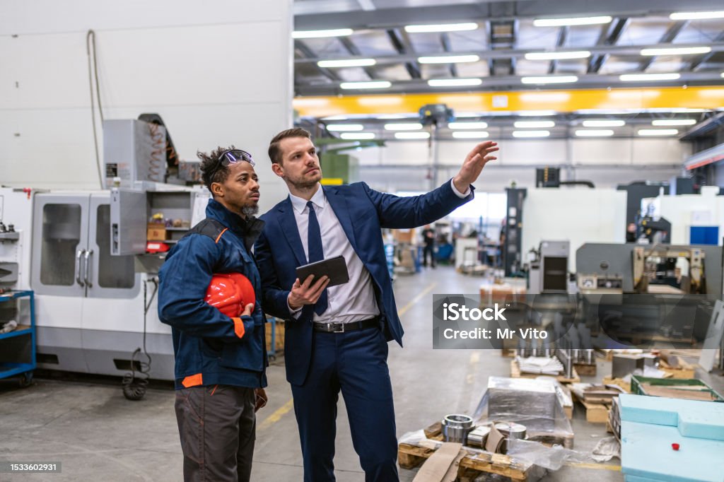 Mechanic checks car undercarriage in GMG-compliant noise-controlled workshop