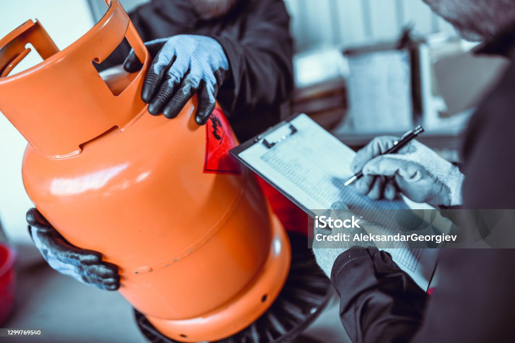 Mechanic checks car undercarriage in GMG-compliant noise-controlled workshop