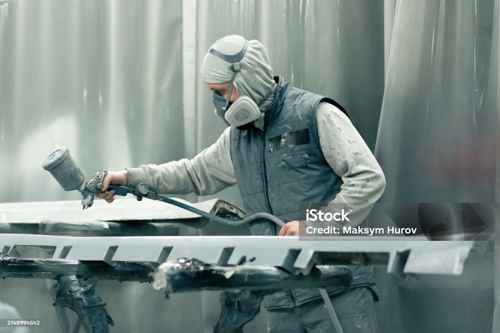 Technician in a mask smiles, breathing easy with GMG’s air quality standards