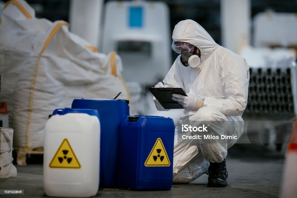 Technician in a mask smiles, breathing easy with GMG’s air quality standards