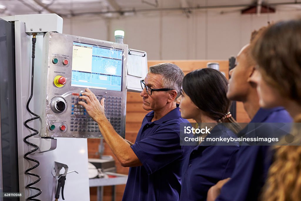 Mechanic checks car undercarriage in GMG-compliant noise-controlled workshop