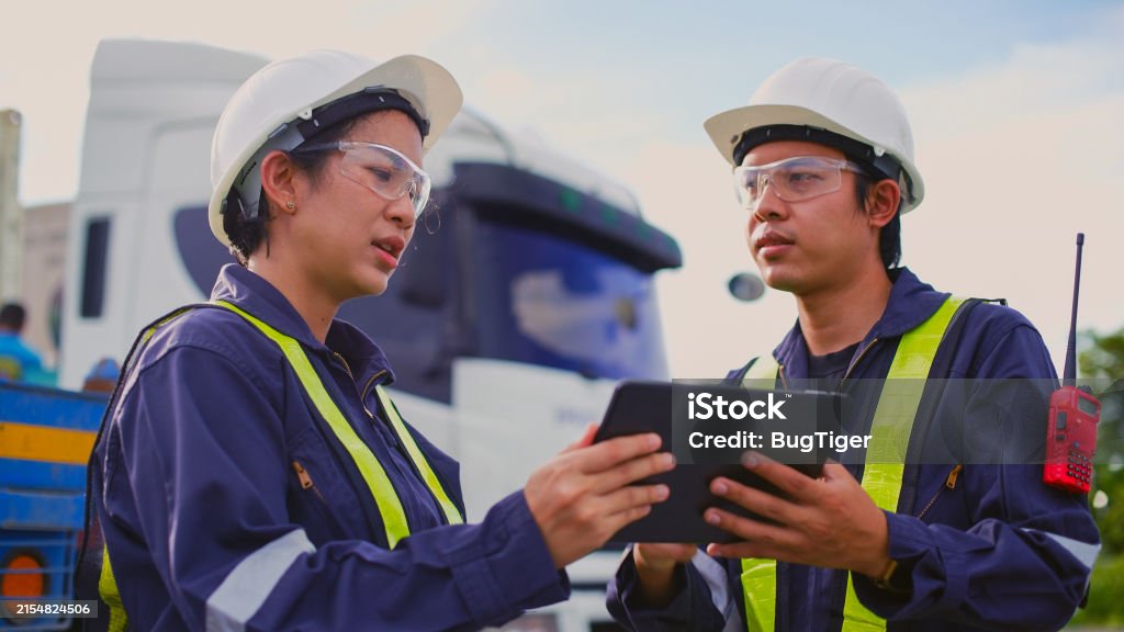 Mechanic responsibly refilling fluids, mindful of GMG's hazardous material protocols