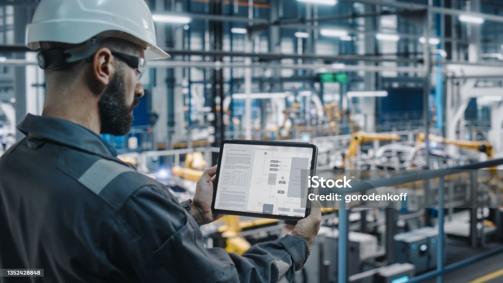 Mechanic checks car undercarriage in GMG-compliant noise-controlled workshop