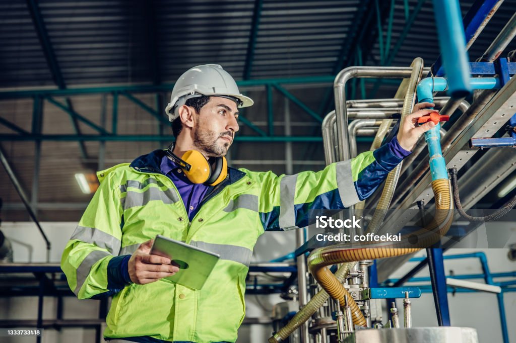 Mechanic checks car undercarriage in GMG-compliant noise-controlled workshop